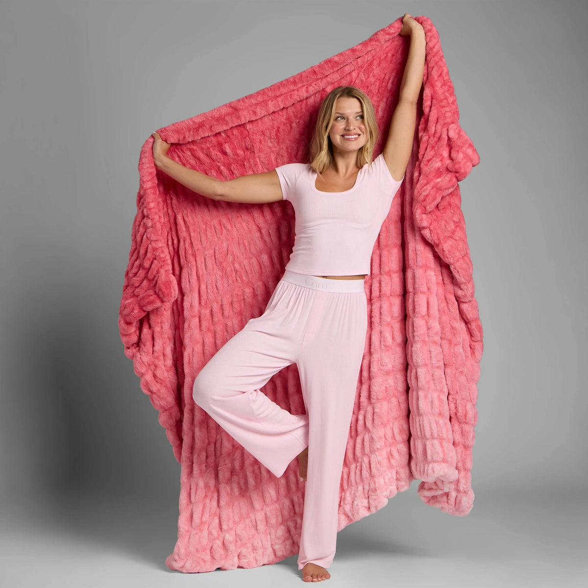 Pink Dreamer plush blanket held open to show oversized coverage